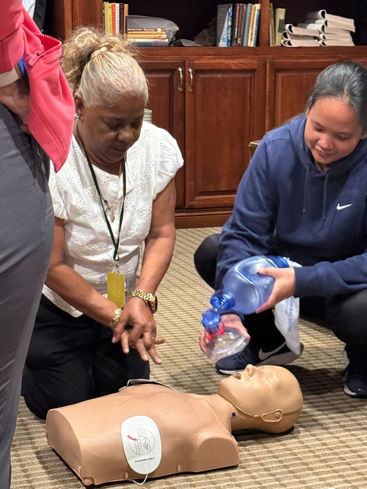 A student guiding a classmate through bag-mask ventilation.